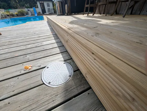 Stepped front edge of the new raised decking faced with decking boards, Ayr