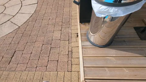 New decking under the outdoor kitchen units next to the pool in Ayr