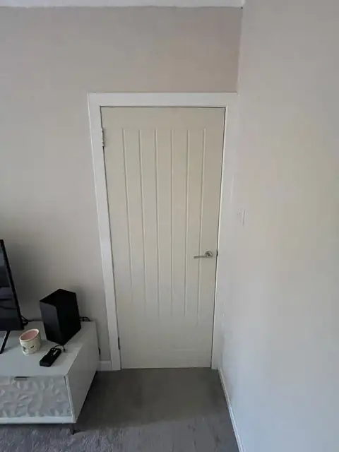 Cottage style internal door fitted in a carpeted room in Ayr, with a lever handle