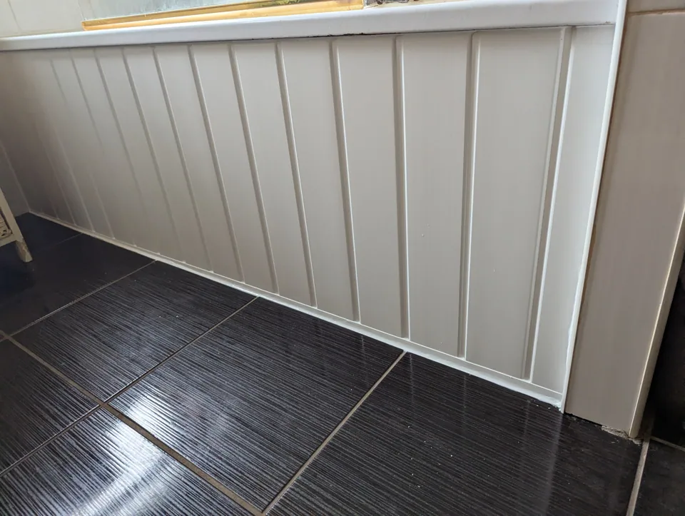 New uPVC bath panel fitted in an Irvine bathroom, cut and scribed to suit the tiled floor
