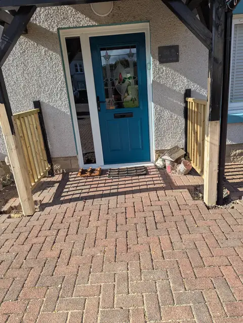 Front door canopy in Irvine standing on repaired timber legs, with new timber balustrading fitted to each side of the entrance