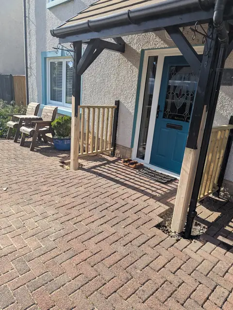 Repaired front door canopy in Irvine, with new treated timber spliced into the bottom of each leg