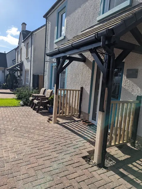 Timber door canopy on a house in Irvine after the legs were repaired and balustrading added