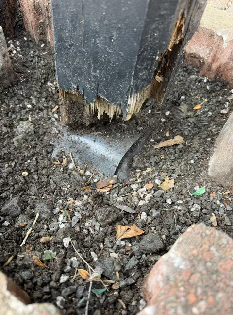 The bottom of a black painted canopy leg in Irvine rotted and breaking away where it met the ground