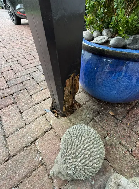 Rot at the base of the second canopy leg, with the timber split and soft at ground level