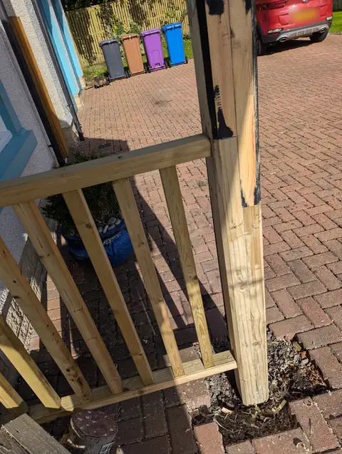 New length of treated timber spliced into the bottom of a canopy leg, with new balustrading alongside