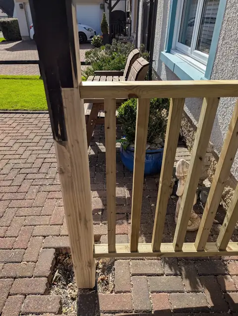 Close view of the splice where new timber joins the original canopy leg, beside the new timber balustrade
