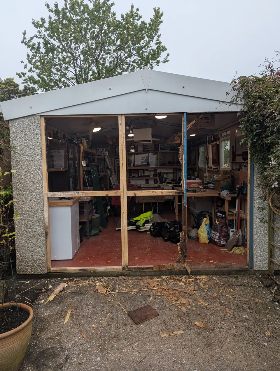 The garage opening stripped back before the new front was built, with the workshop visible inside
