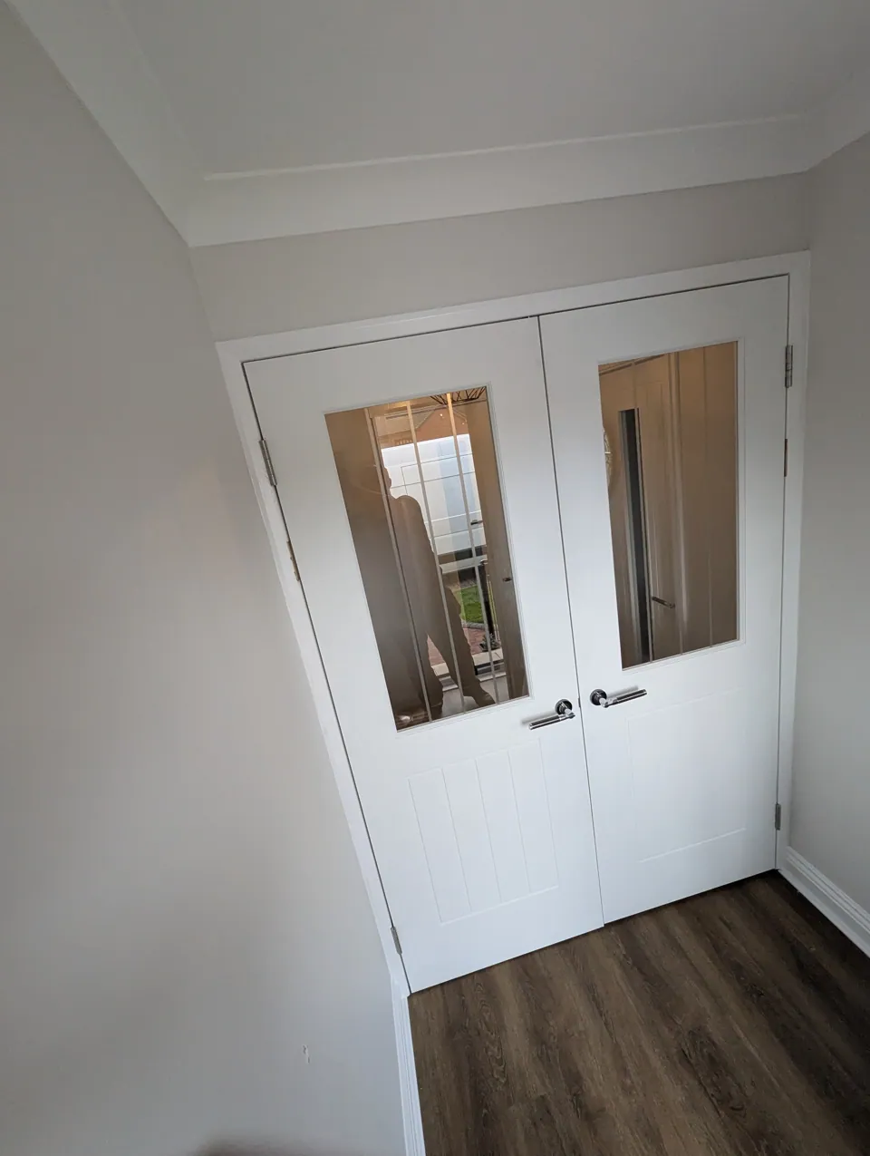 A pair of glazed white double doors fitted to a wider opening in an Irvine home