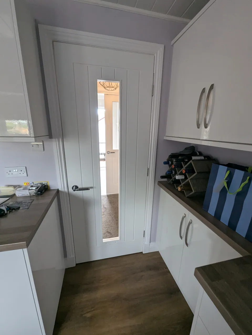 Glazed white internal door seen from the kitchen, carrying natural light between rooms