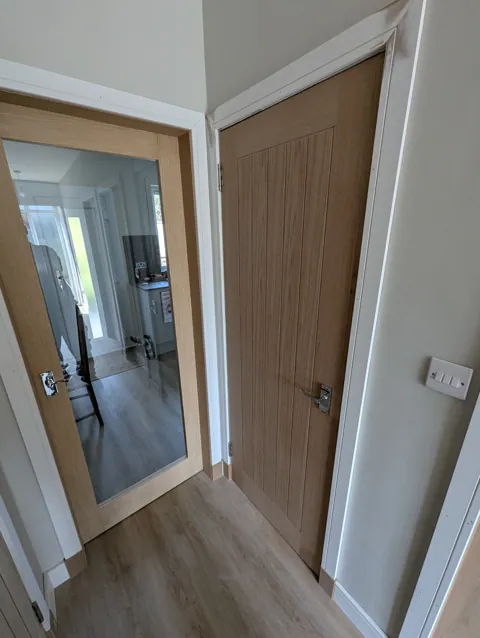 Glazed oak door and cottage style oak door side by side with new white facings in Irvine