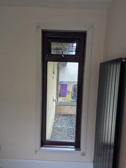Second window in the same Irvine home finished with the sill cut back and a chamfered facing run around the opening