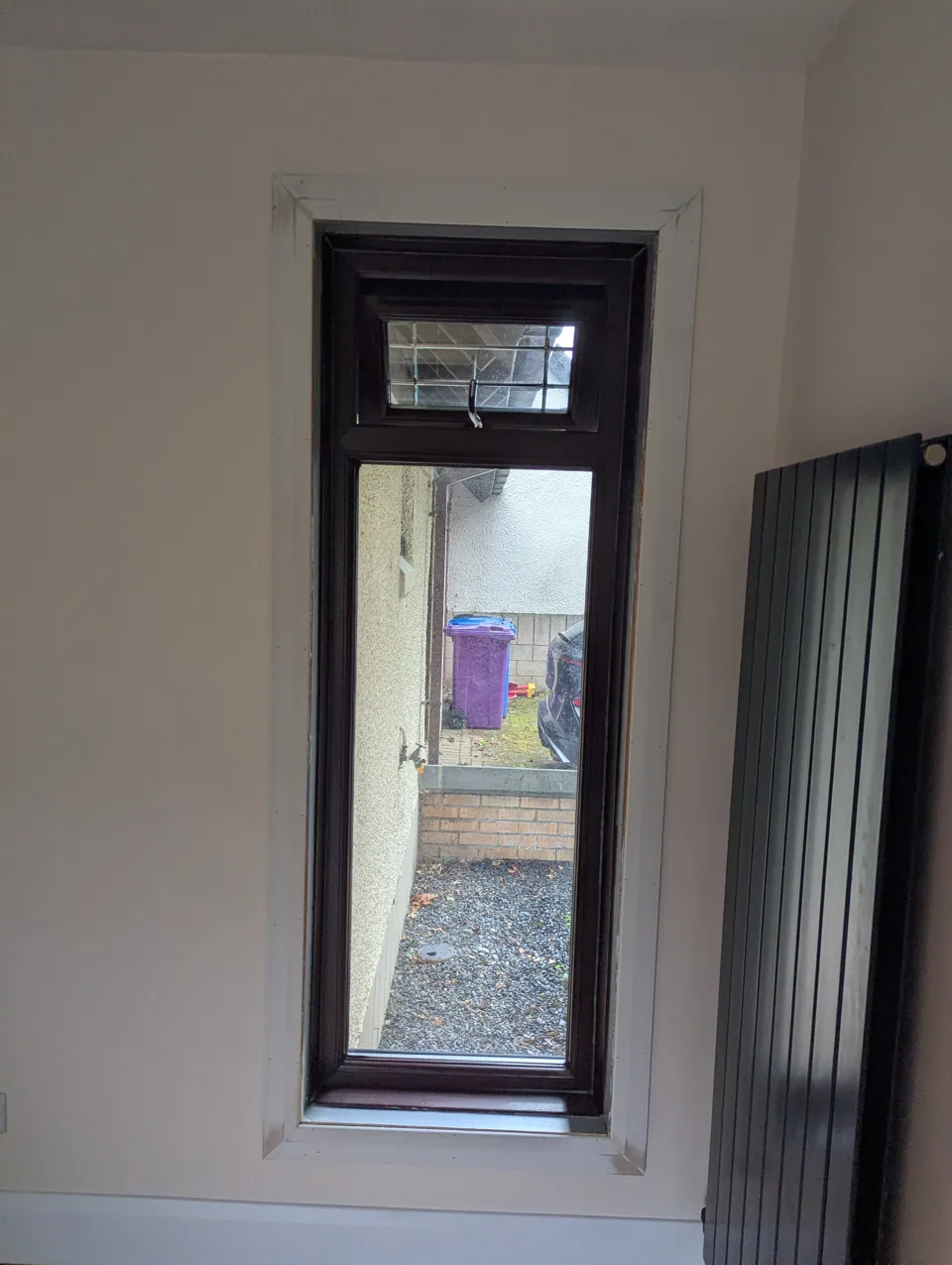 Second window in the same Irvine home finished with the sill cut back and a chamfered facing run around the opening