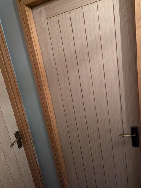 Two oak veneered doors on the same landing with matching antique brass handles