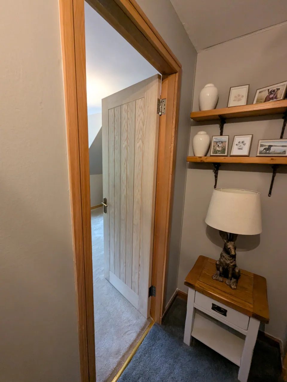 Oak veneered door standing open, showing the hinge side and the edge of the door