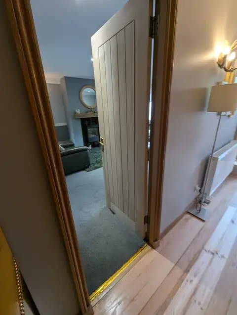 Oak veneer cottage door standing open through to the living room in Lugton