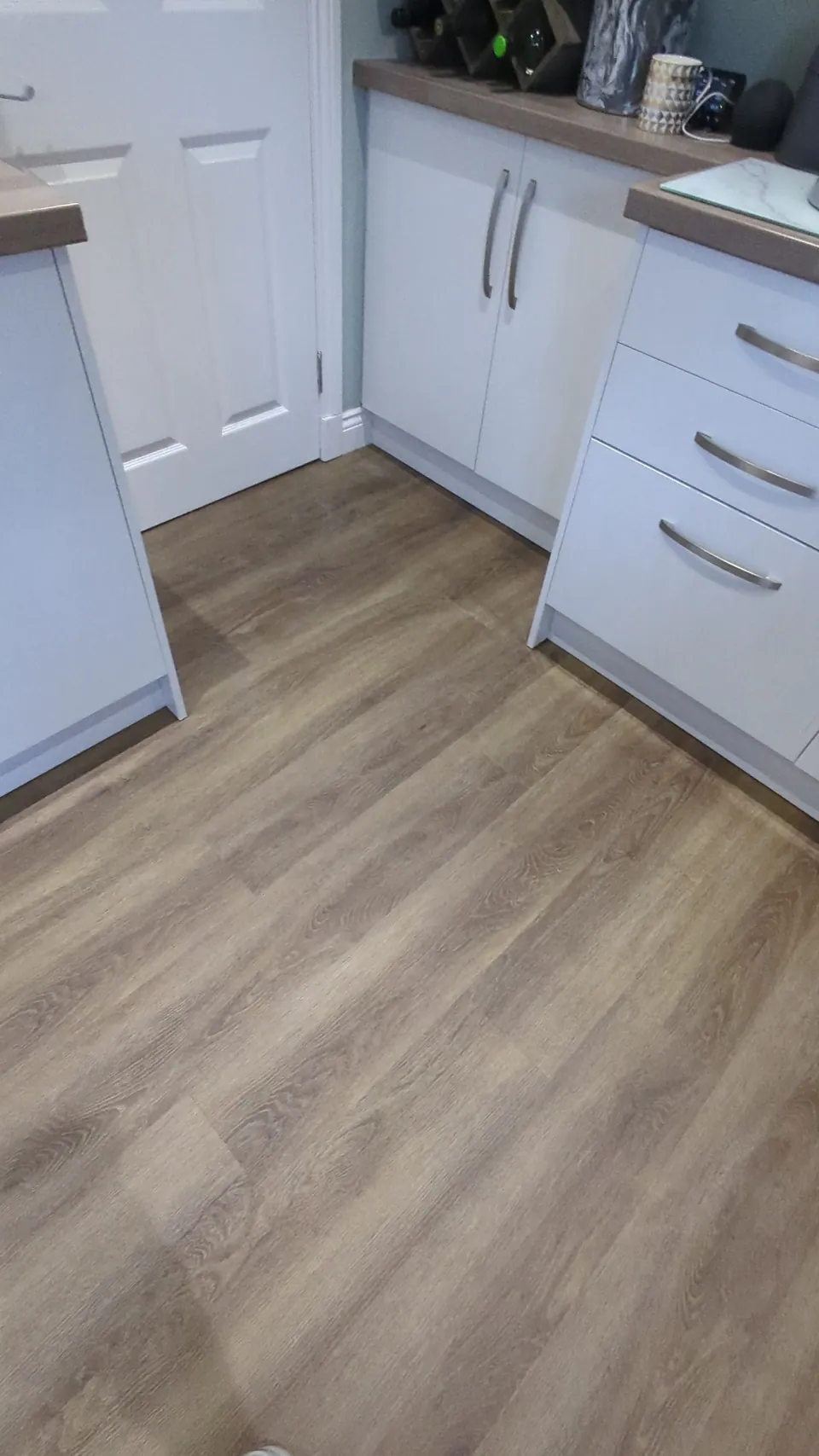 LVT flooring laid through a kitchen in Irvine, cut in neatly around the base units