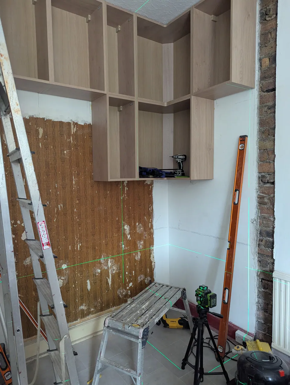 Wall units being fitted inside the pantry recess