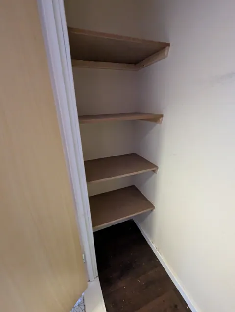 Four MDF shelves on timber bearers fitted inside a cupboard in Irvine