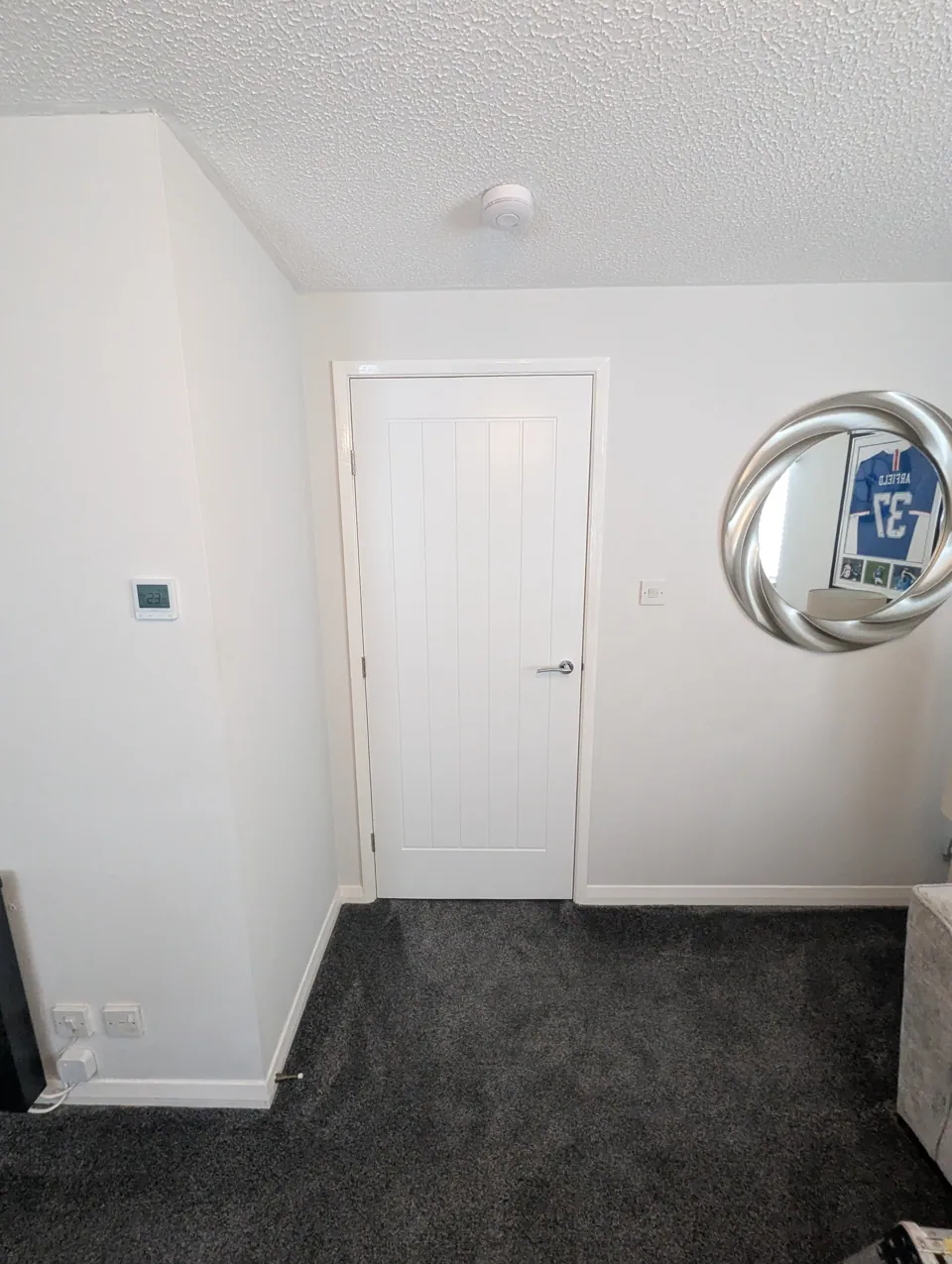 Prefinished white cottage style door hung in a Prestwick bedroom with chrome handle and white facings