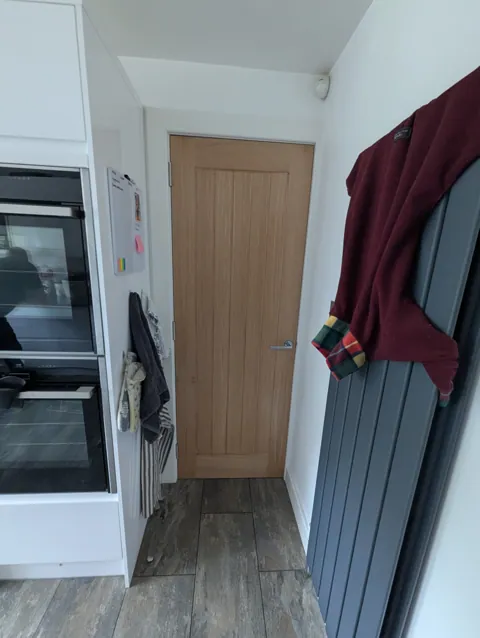 Prefinished oak door fitted next to the oven housing in a Prestwick kitchen