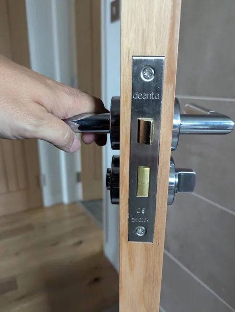 Deanta latch and thumbturn privacy set fitted to a prefinished oak bathroom door in Prestwick