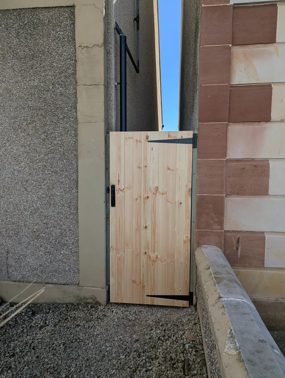 Timber garden gate built and fitted in a close between two properties in Saltcoats