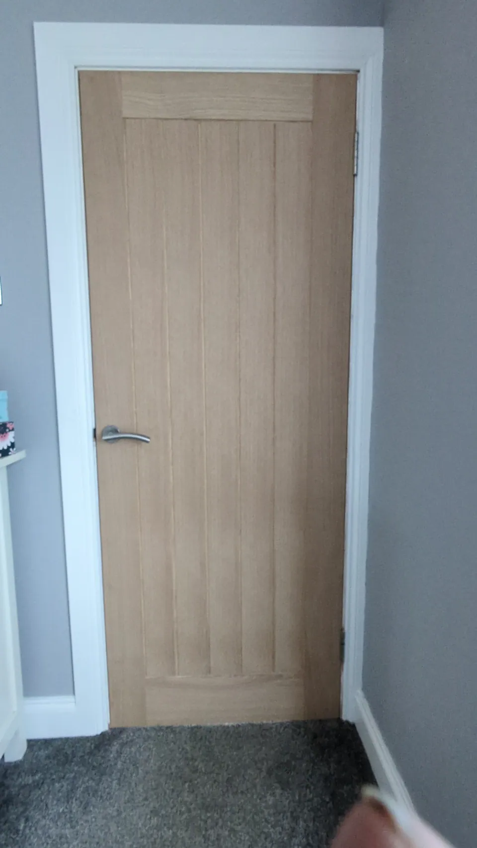 Oak veneered internal door hung in a Troon home with a chrome lever handle, matched to the existing doors