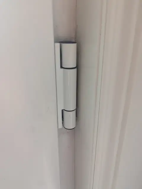 New white uPVC door hinge fitted to the door and frame