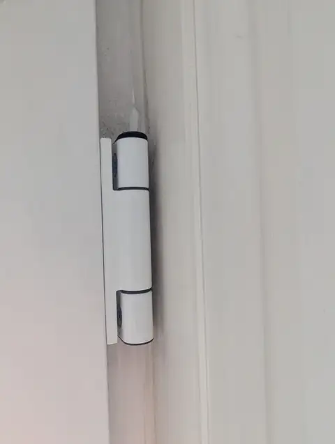 New uPVC door hinge fitted and aligned, with the door sitting square in the frame