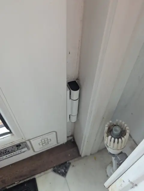 uPVC door closed and sitting square in its frame after new hinges were fitted and the door adjusted